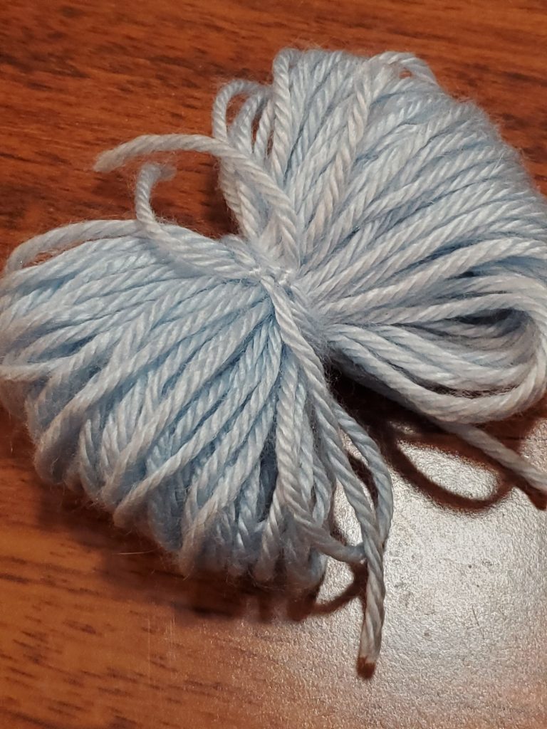 tie yarn around the wrapped yarn